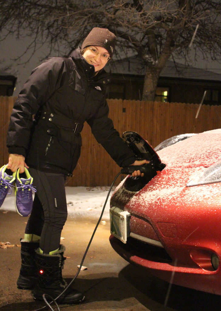 Eva with the Leaf, beating the cold with a battery-powered car and battery-heated boots on her feet.