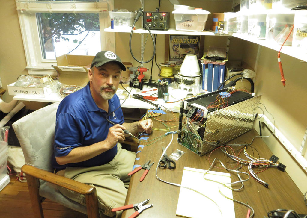 Each battery module is enclosed in a water- and salt-proof box. The BMS (Battery Management System) is also housed in the box, which Bill is installing in the picture. 